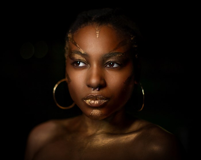 Portrait of African Woman with Gold Face Paint