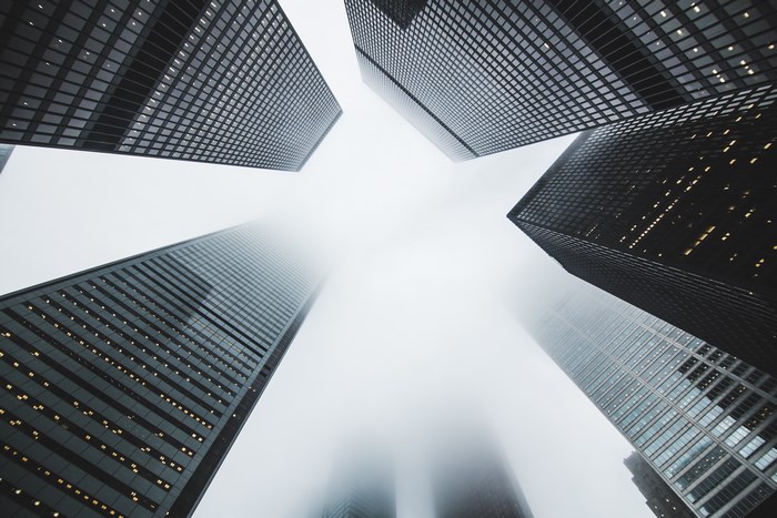 Skyscrapers in the fog, looking up