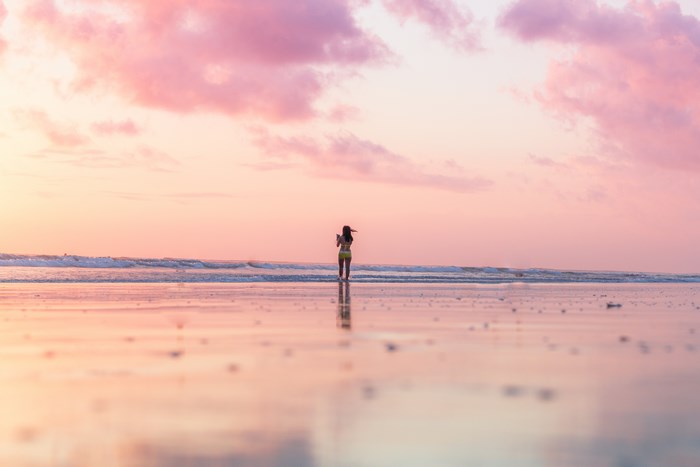 Woman on a beach at sunset in Bali, Indonesia