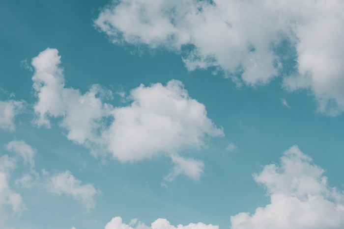Minimalist blue sky with white clouds