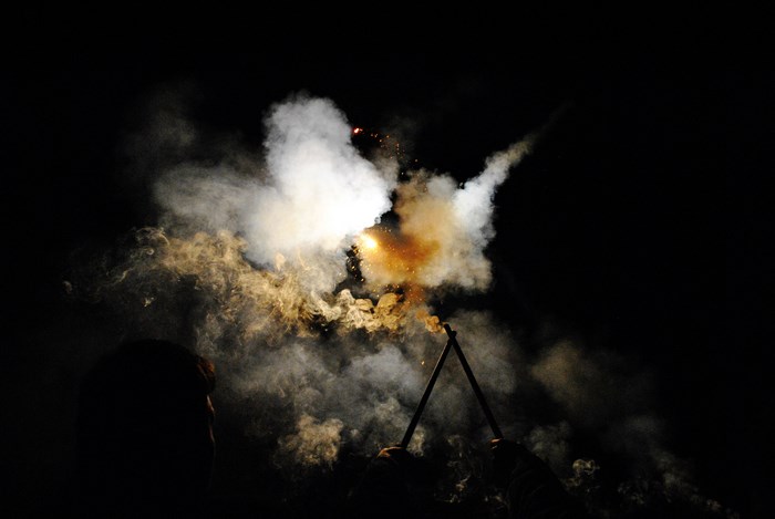 People holding flares in the dark