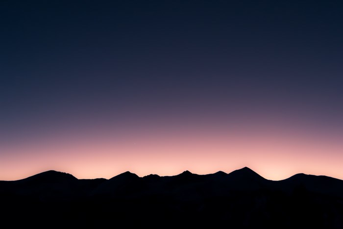 Silhouette of mountains against a twilight sky