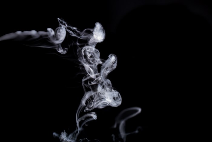 Abstract white smoke against a black background