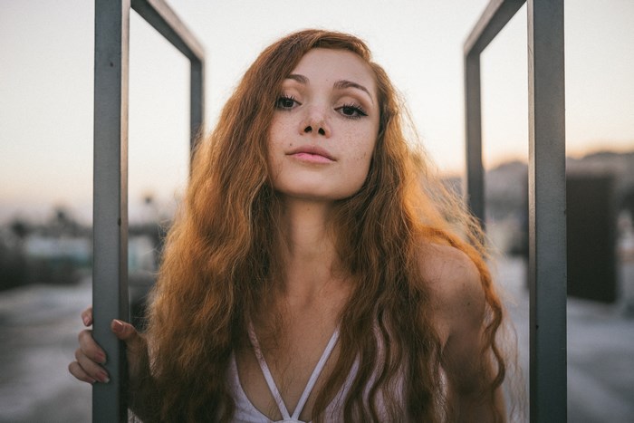 Ginger Woman Posing on Rooftop at Dusk