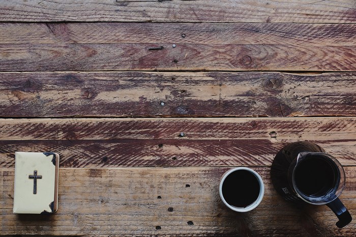 Bible and coffee on a wooden table