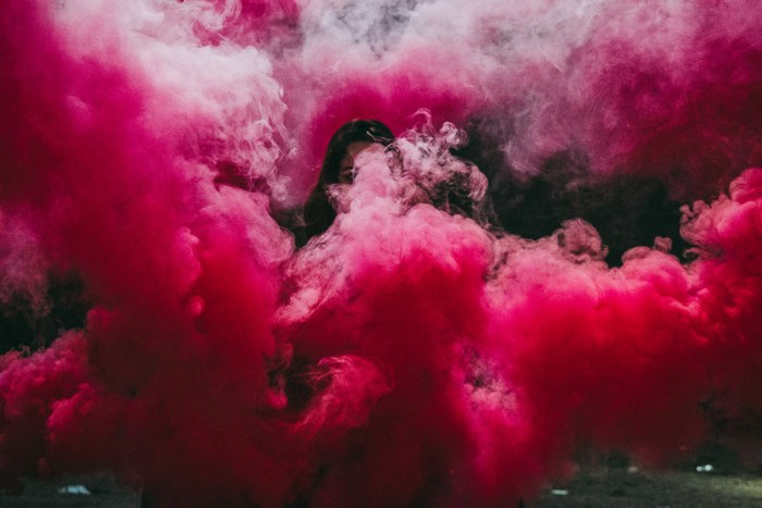 Person obscured by pink smoke
