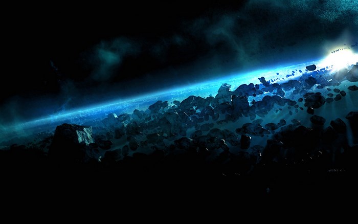 Asteroid belt near a glowing planet