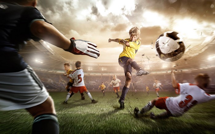 Children playing football in a stadium