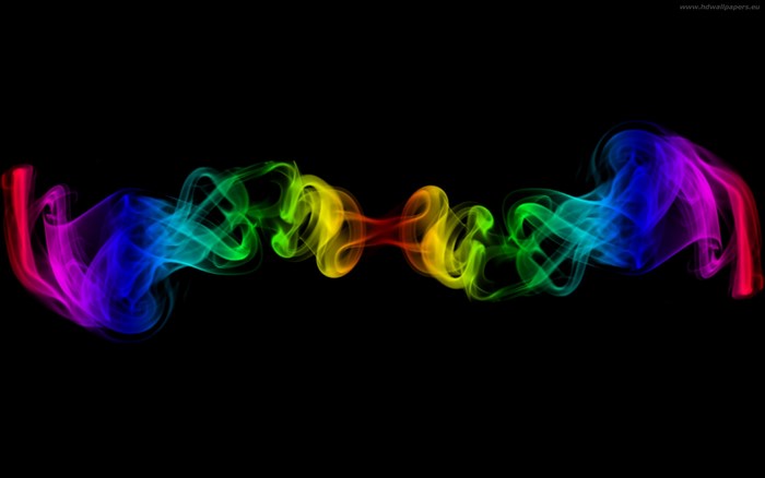 Rainbow smoke swirls on black background