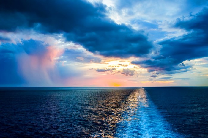Ocean waves and dramatic sunset clouds