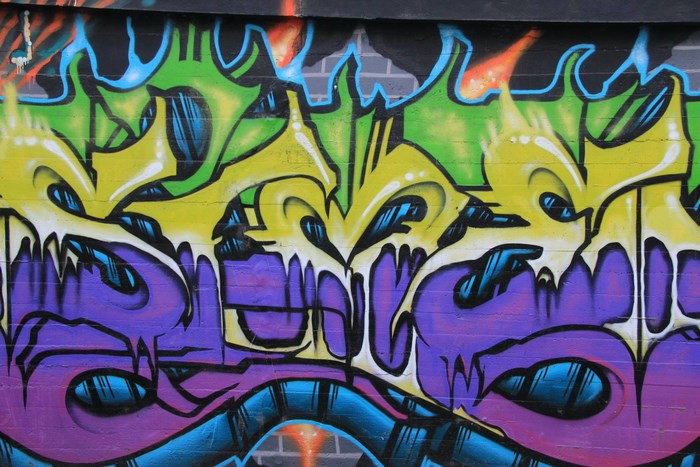 Graffiti art with purple, yellow, and green colors