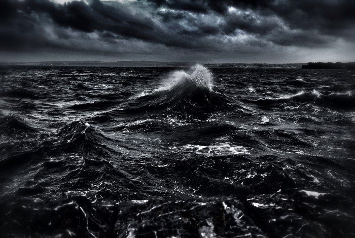 Dark stormy ocean waves crashing