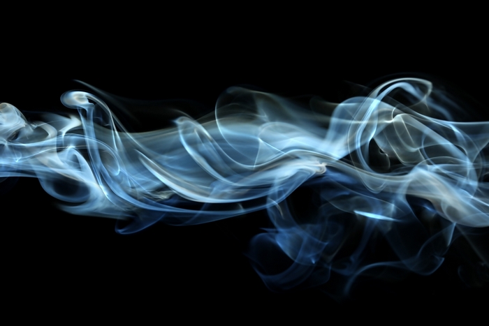 Blue and white smoke wisps on black background