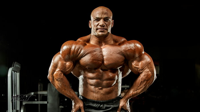 Muscular Bodybuilder Posing in Gym