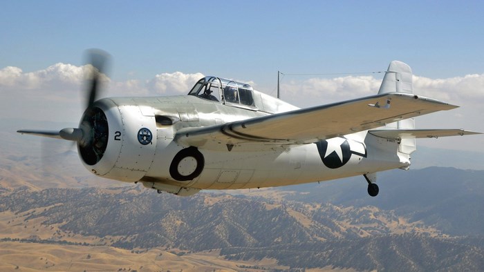 Grumman F4F Wildcat in flight over mountains