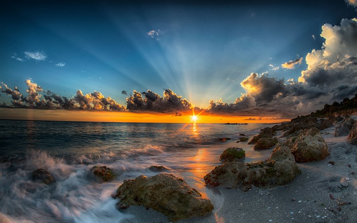 Sunset over the ocean with dramatic clouds