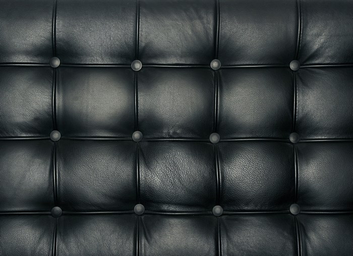 Black tufted leather sofa texture