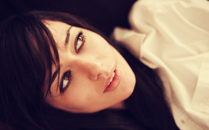 Woman in white shirt lying down