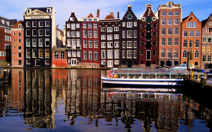 Amsterdam canal with canal boat and historic buildings