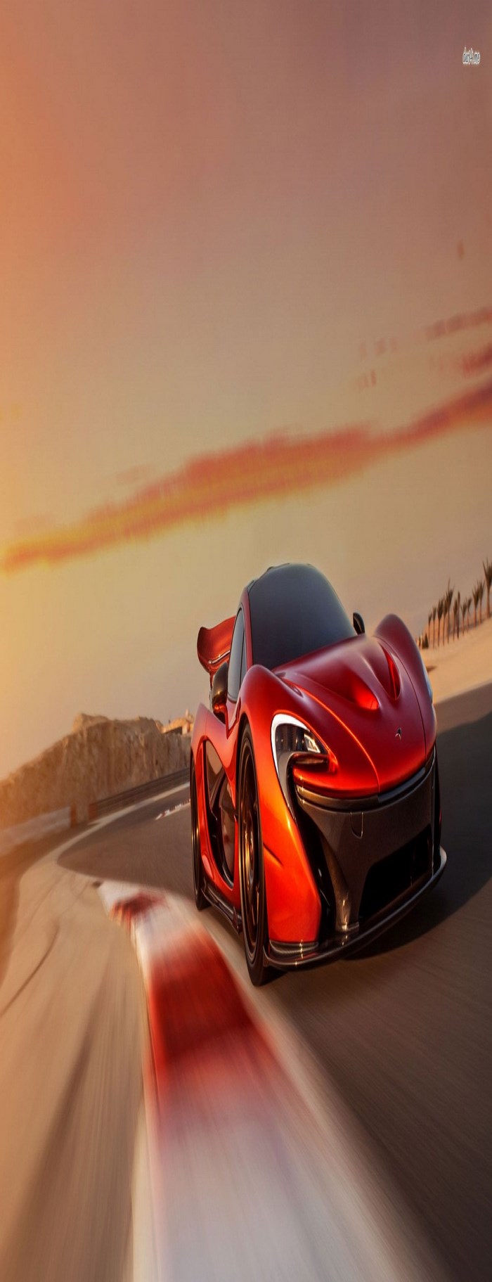 McLaren P1 on a race track at sunset