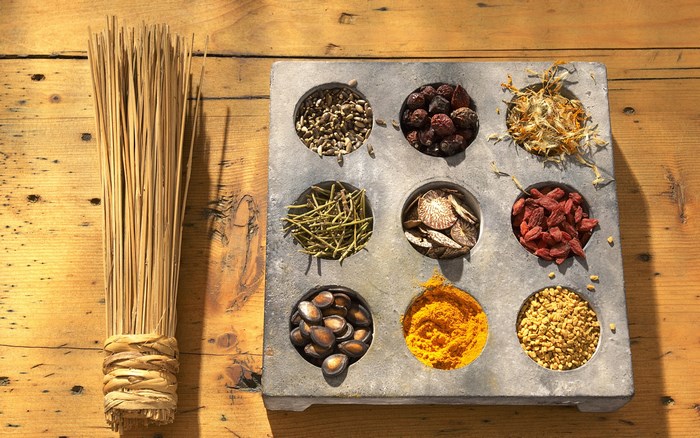 Herbs and spices in a tray with dried reeds