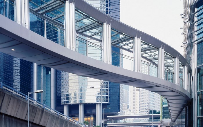 Modern elevated walkway between glass buildings