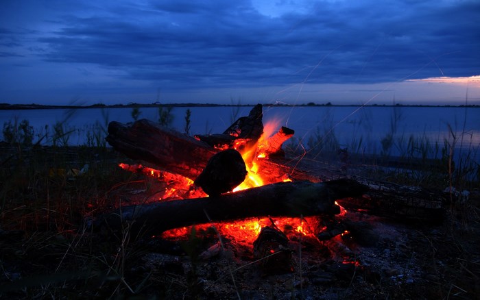 Campfire by the lake at dusk