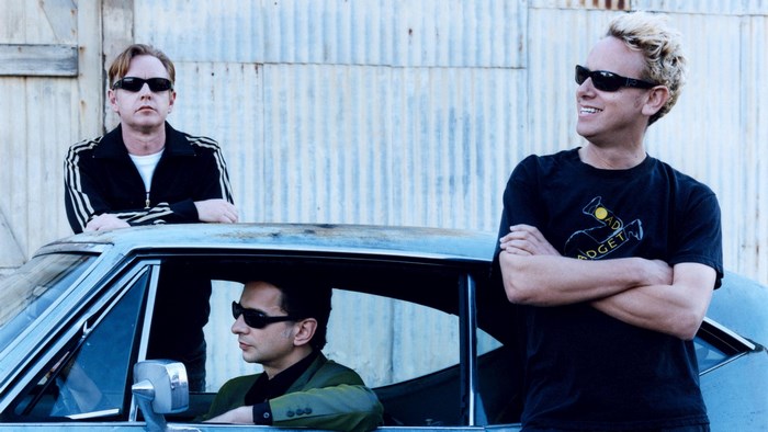 Depeche Mode band members by a car