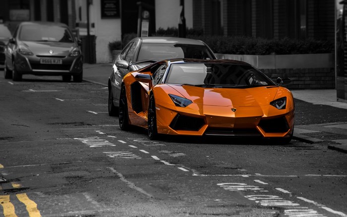 Orange Lamborghini Aventador parked on street