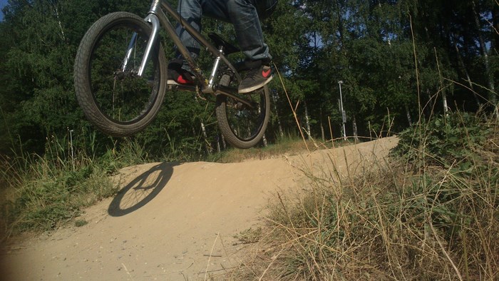 BMX rider jumping on a dirt track