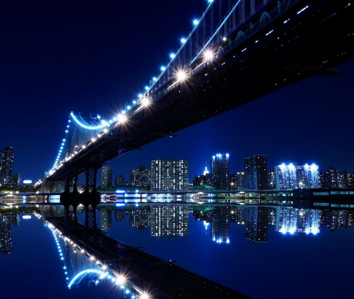 Manhattan Bridge at Night with City Skyline Reflection