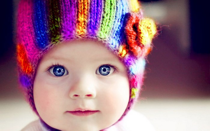 Baby wearing a colorful knitted hat