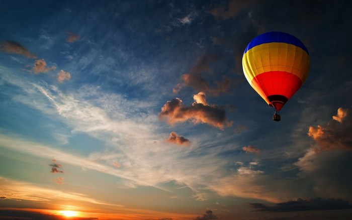 Hot air balloon flying at sunset