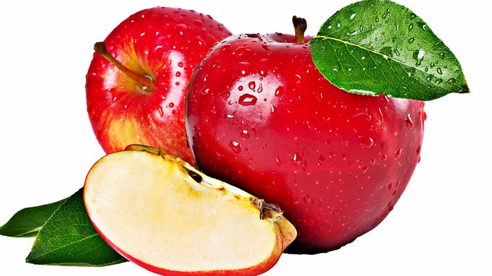 Red apples with water droplets and a slice