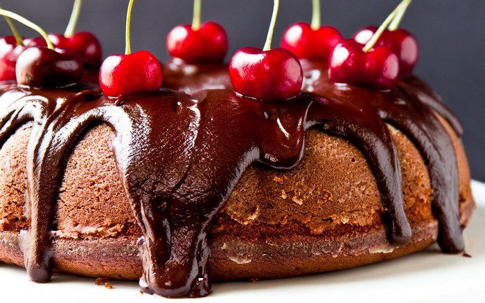 Chocolate bundt cake with chocolate glaze and cherries