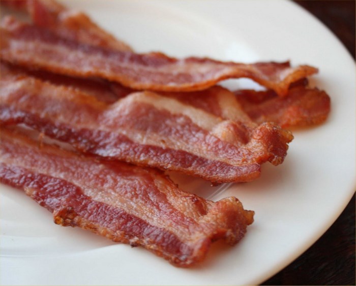 Crispy Bacon Strips on a White Plate