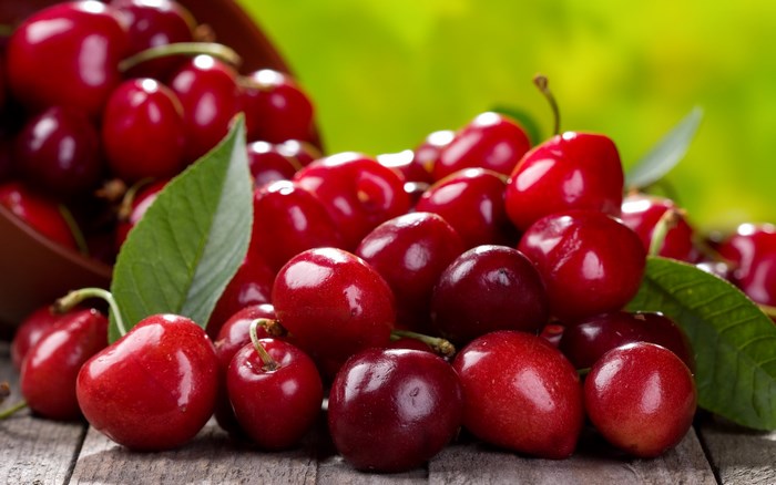 Cherries in a bowl on a wooden table
