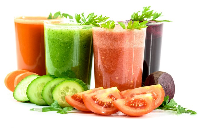 Four glasses of fresh juices with vegetables and fruits