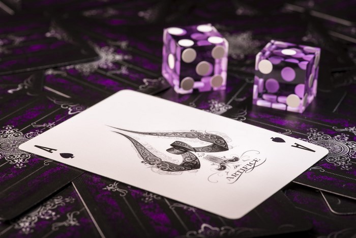 Ace of Spades card with dice and playing cards