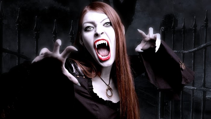Vampire woman with fangs and white eyes