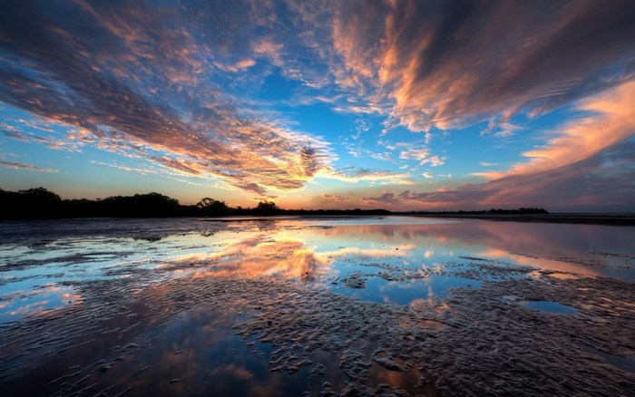 Sunset reflection over water and mudflats