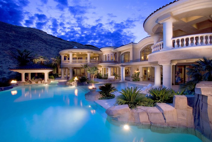 Luxury mansion with swimming pool at dusk