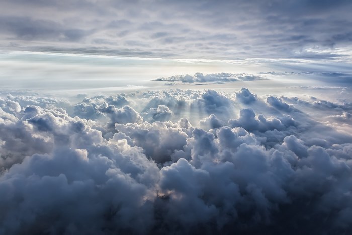 Sunbeams piercing through clouds from above