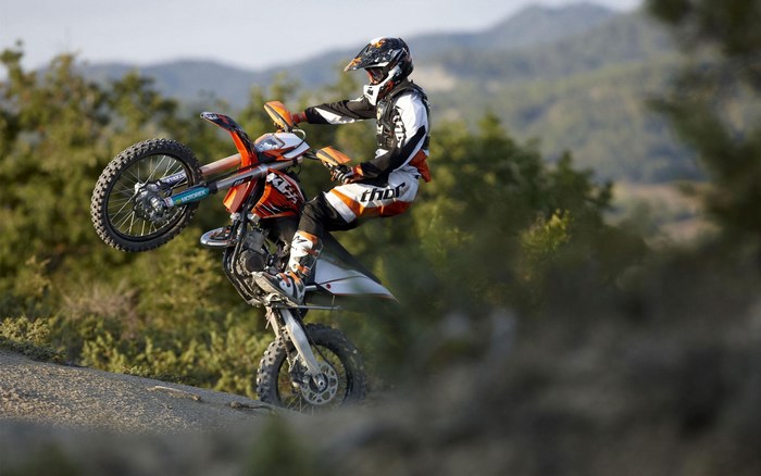 KTM Motorcycle Rider Performing a Wheelie