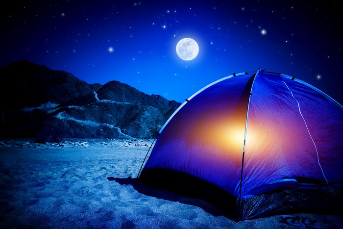 Tent under the moon and stars