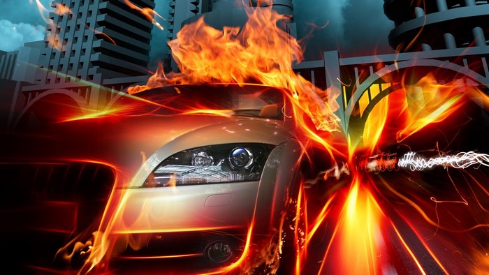 Car on fire in a city