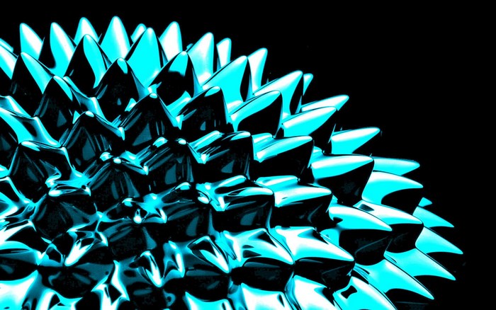 Turquoise ferrofluid spikes on black background
