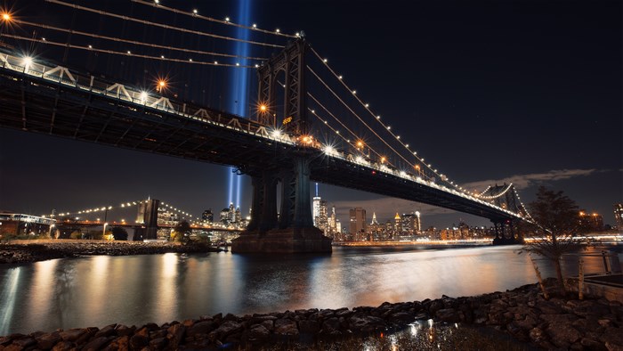 4K Night View of Illuminated Suspension Bridge Over Water
