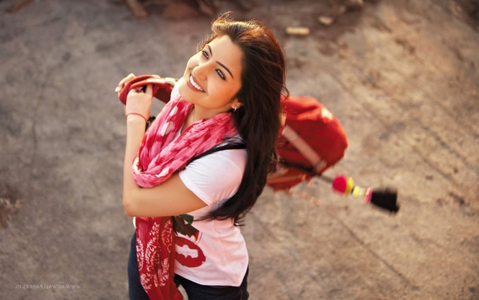 Anushka Sharma with a red scarf and bag
