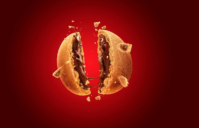 Chocolate cookie broken in half with molten chocolate